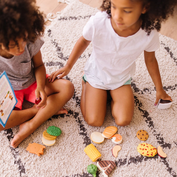 A kid playing with the Food Fun Combine & Dine Dinners - Blue