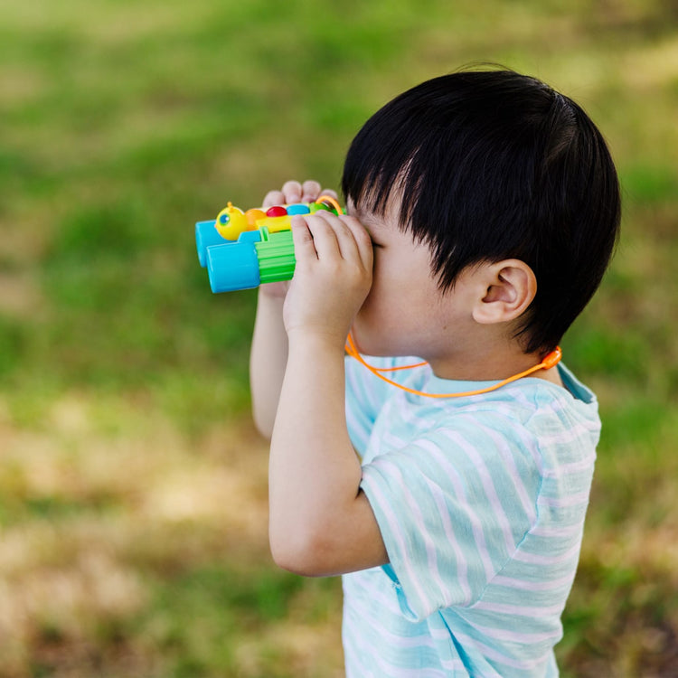 A kid playing with the Melissa & Doug Sunny Patch Giddy Buggy Binoculars - Pretend Play Toy