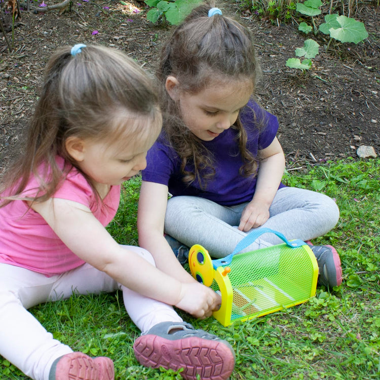 A kid playing with the Melissa & Doug Sunny Patch Giddy Buggy Bug House Toy With Carrying Handle and Easy-Access Door