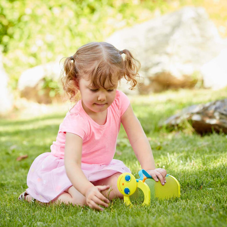 A kid playing with the Melissa & Doug Sunny Patch Giddy Buggy Bug House Toy With Carrying Handle and Easy-Access Door