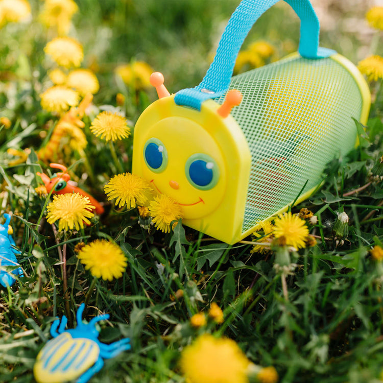 A kid playing with the Melissa & Doug Sunny Patch Giddy Buggy Bug House Toy With Carrying Handle and Easy-Access Door