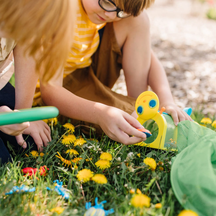 A kid playing with the Melissa & Doug Sunny Patch Giddy Buggy Bug House Toy With Carrying Handle and Easy-Access Door