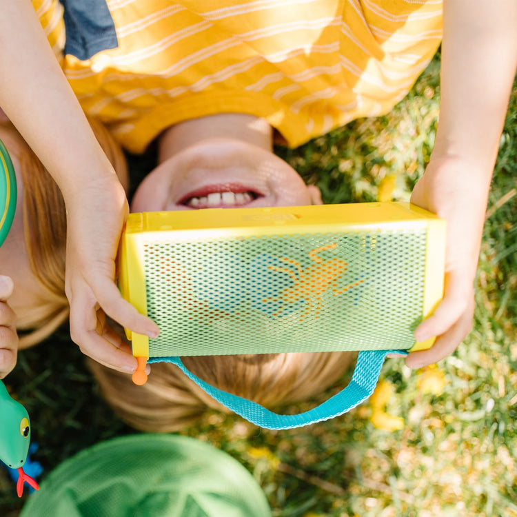 A kid playing with the Melissa & Doug Sunny Patch Giddy Buggy Bug House Toy With Carrying Handle and Easy-Access Door