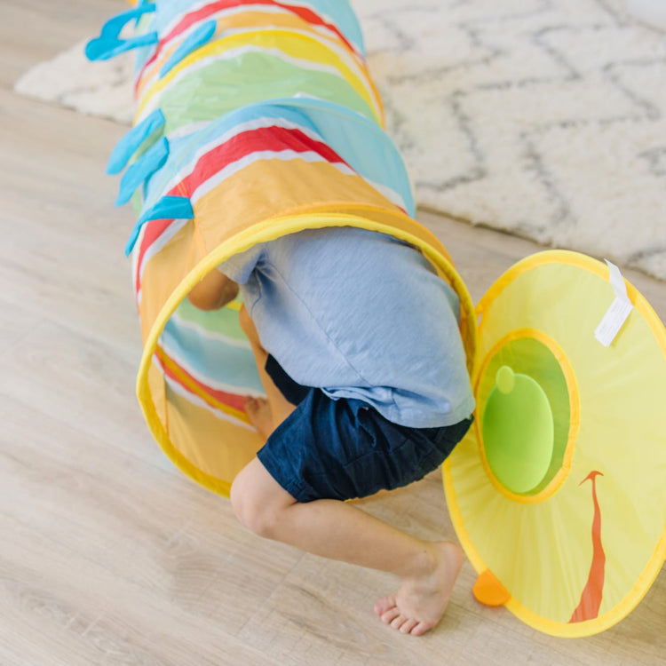 A kid playing with the Melissa & Doug Sunny Patch Giddy Buggy Crawl-Through Tunnel (almost 5 feet long)