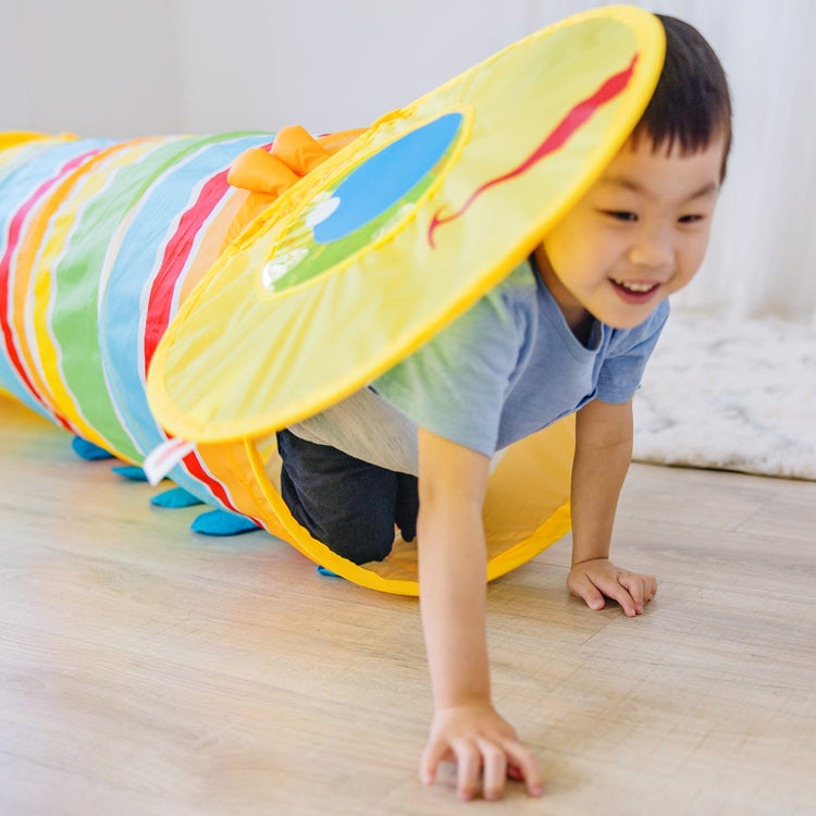 A kid playing with the Melissa & Doug Sunny Patch Giddy Buggy Crawl-Through Tunnel (almost 5 feet long)