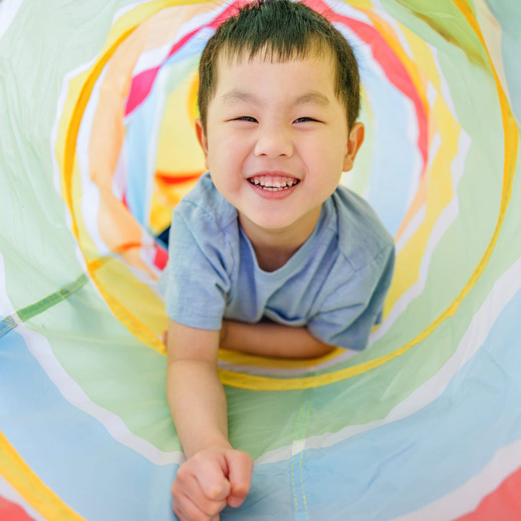 A kid playing with the Melissa & Doug Sunny Patch Giddy Buggy Crawl-Through Tunnel (almost 5 feet long)