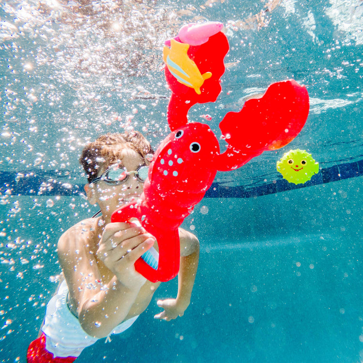 A kid playing with the Melissa & Doug Sunny Patch Louie Lobster Claw Catcher - Grab-and-Squeeze Pool Toy