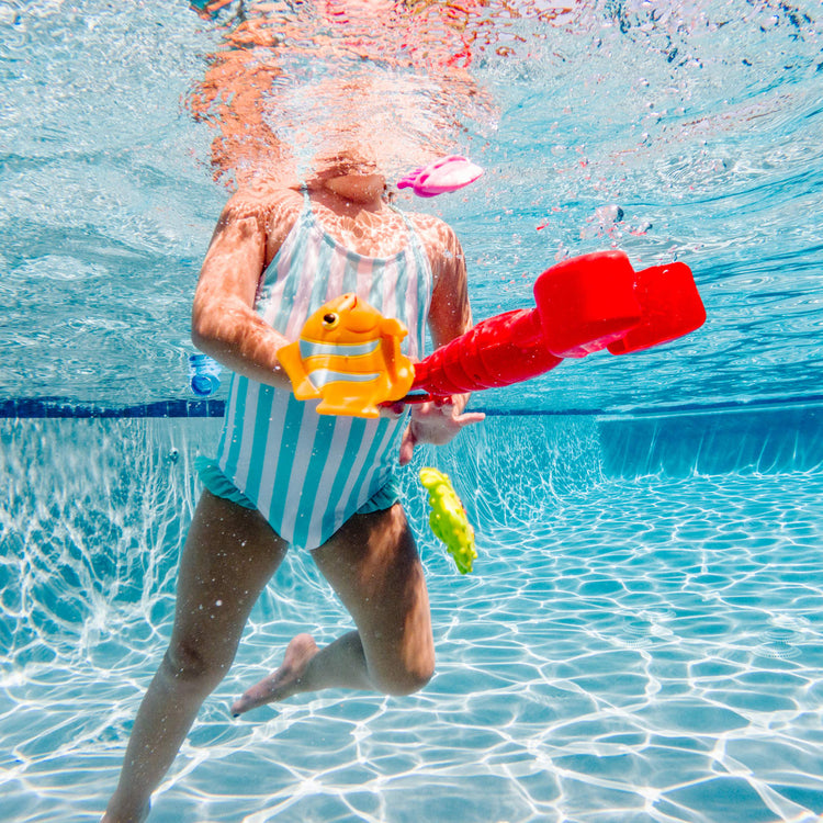 A kid playing with the Melissa & Doug Sunny Patch Louie Lobster Claw Catcher - Grab-and-Squeeze Pool Toy