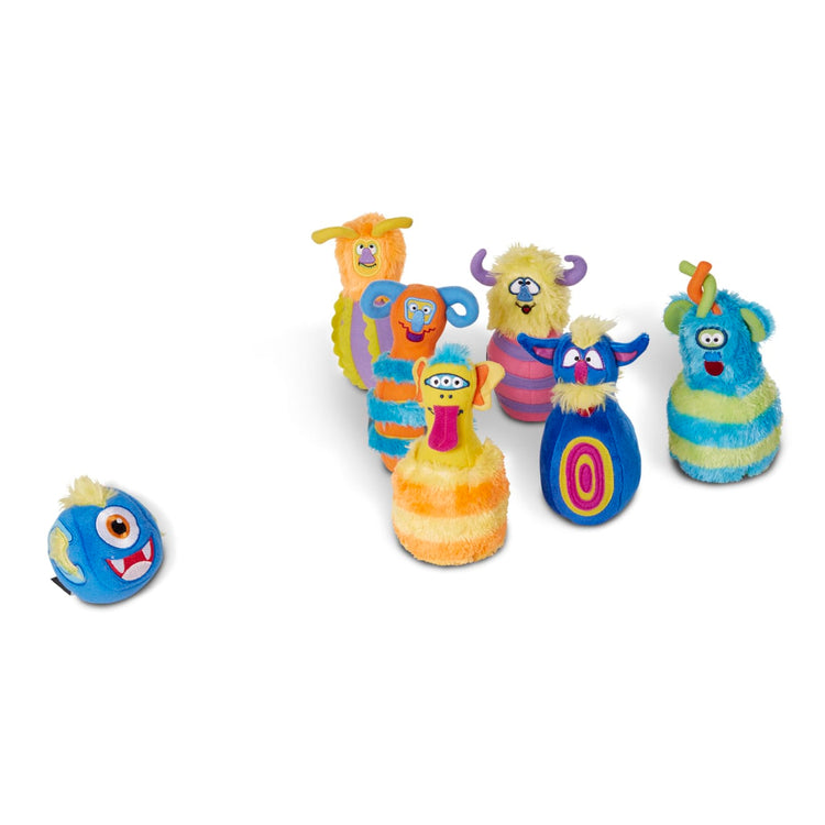 The loose pieces of the Melissa & Doug Fuzzy Monster Bowling Pins & Ball With Mesh Storage Bag (8-Piece Set)