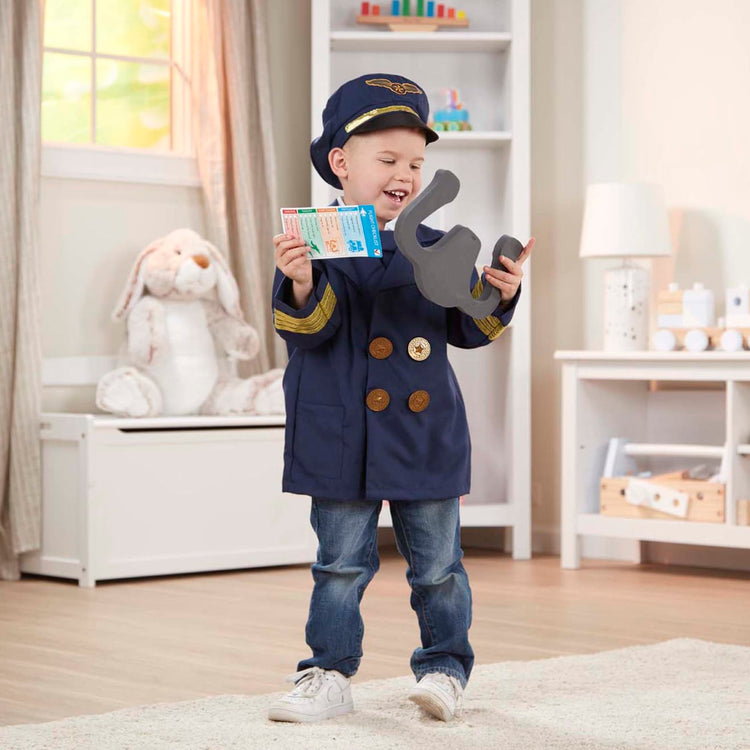 A kid playing with the Melissa & Doug Pilot Costume Role Play Set (6 pcs) - Jacket, Tie, Hat, Wings, Steering Yoke, Checklist