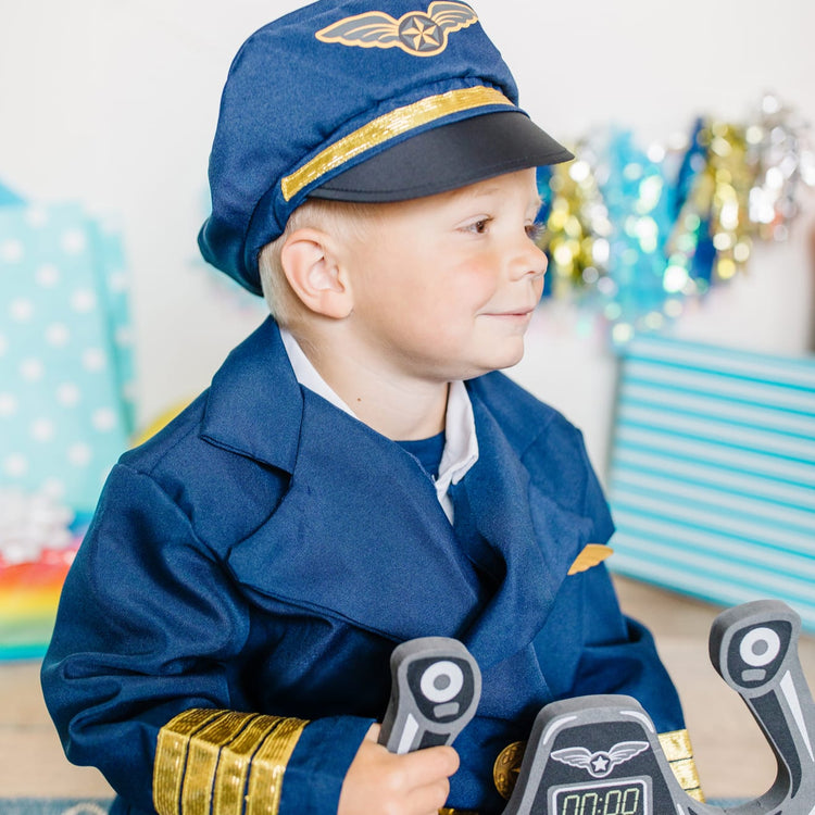 A kid playing with the Melissa & Doug Pilot Costume Role Play Set (6 pcs) - Jacket, Tie, Hat, Wings, Steering Yoke, Checklist