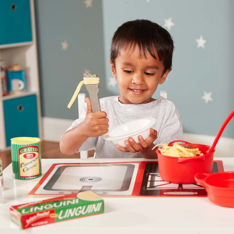 A kid playing with the Melissa & Doug Prepare & Serve Pasta Play Food Set - 55 Pieces