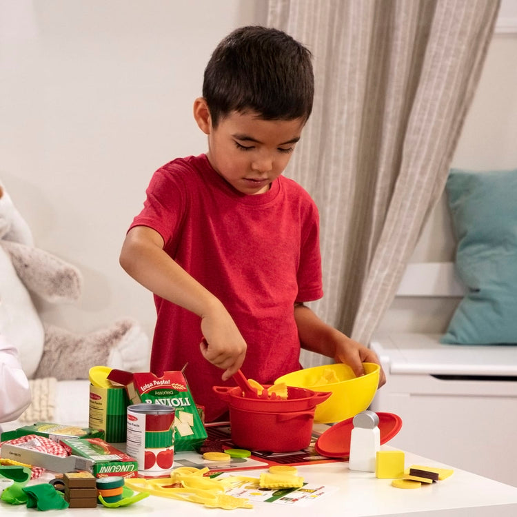 A kid playing with the Melissa & Doug Prepare & Serve Pasta Play Food Set - 55 Pieces