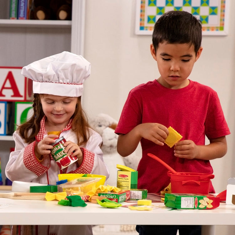 A kid playing with the Melissa & Doug Prepare & Serve Pasta Play Food Set - 55 Pieces