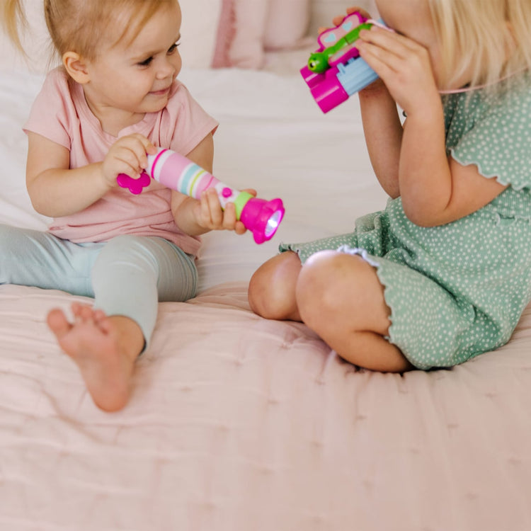 A kid playing with the Melissa & Doug Sunny Patch Pretty Petals Flower Flashlight for Kids