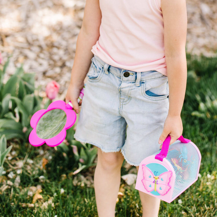 A kid playing with the Melissa & Doug Sunny Patch Pretty Petals Flower Magnifying Glass With Shatterproof Lens