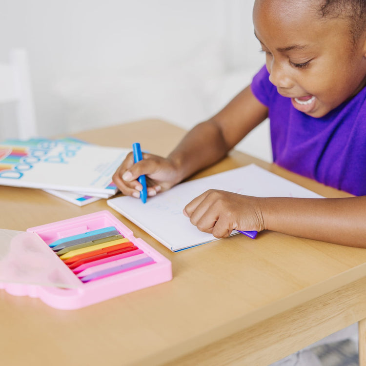 A kid playing with the Melissa & Doug Princess Crayon Set - 12 Colors