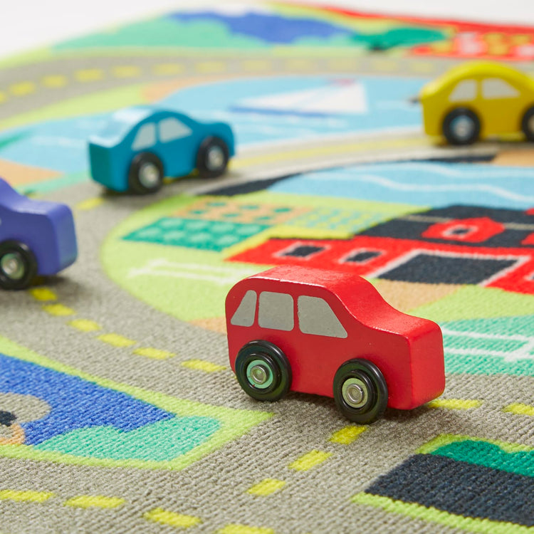 the Melissa & Doug Round the Town Road Rug and Car Activity Play Set With 4 Wooden Cars (39 x 36 inches)