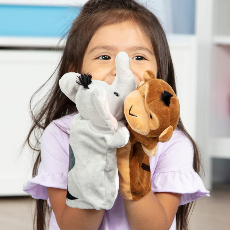 A kid playing with the Melissa & Doug Safari Buddies Hand Puppets, Set of 6 (Elephant, Tiger, Parrot, Giraffe, Monkey, Zebra)