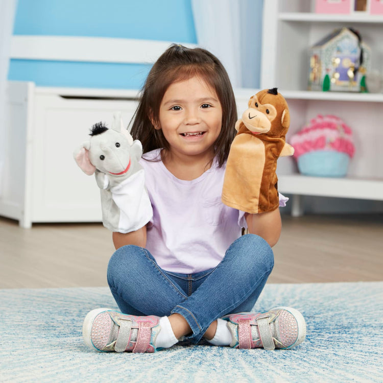 A kid playing with the Melissa & Doug Safari Buddies Hand Puppets, Set of 6 (Elephant, Tiger, Parrot, Giraffe, Monkey, Zebra)