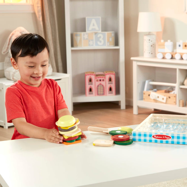 A kid playing with the Melissa & Doug Wooden Sandwich-Making Pretend Play Food Set