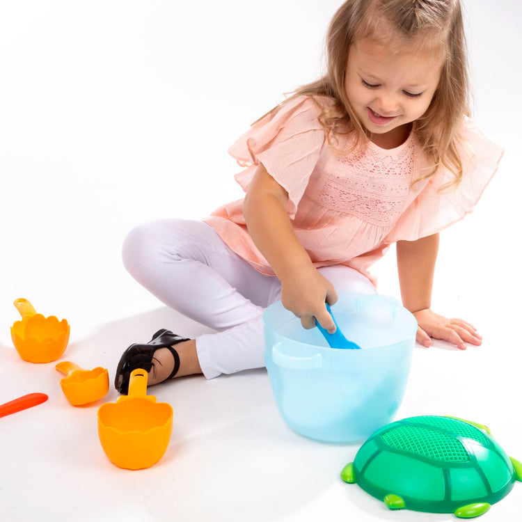 A child on white background with the Seaside Sidekicks Sand Baking Set