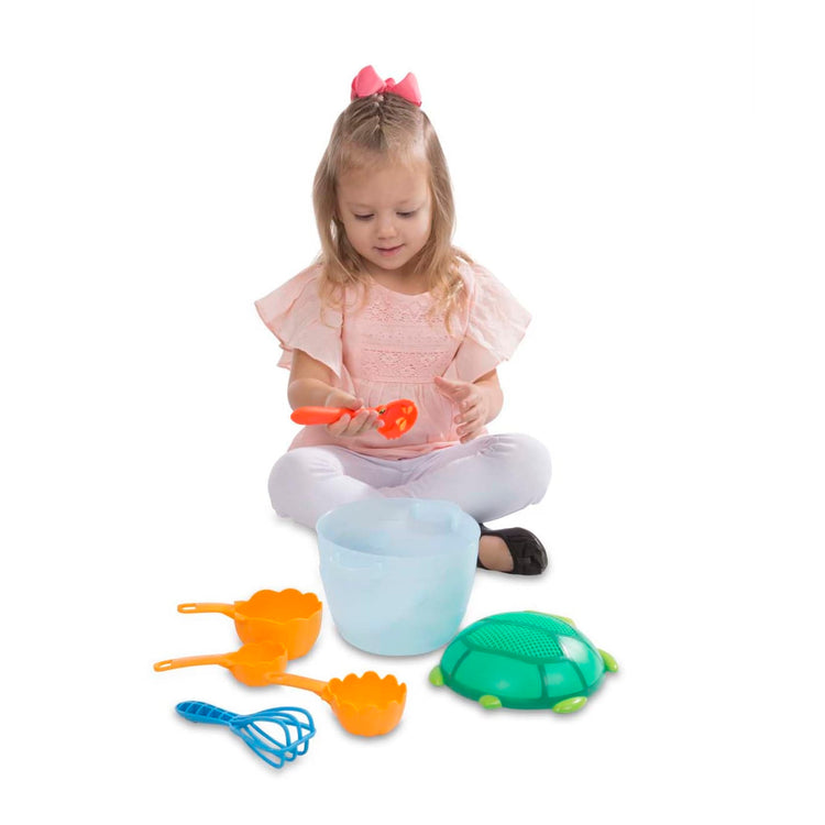 A child on white background with the Seaside Sidekicks Sand Baking Set