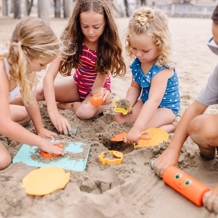 A kid playing with the Melissa & Doug Sunny Patch Seaside Sidekicks Sand Cookie-Baking Set