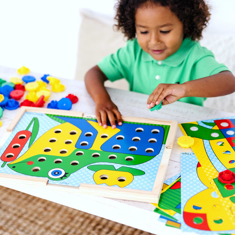 A kid playing with the Melissa & Doug Sort and Snap Color Match - Sorting and Patterns Educational Toy