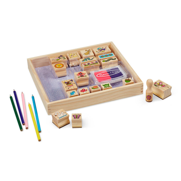 The loose pieces of the Melissa & Doug Stamp-a-Scene Stamp Pad: Fairy Garden - 20 Wooden Stamps, 5 Colored Pencils, and 2-Color Stamp Pad