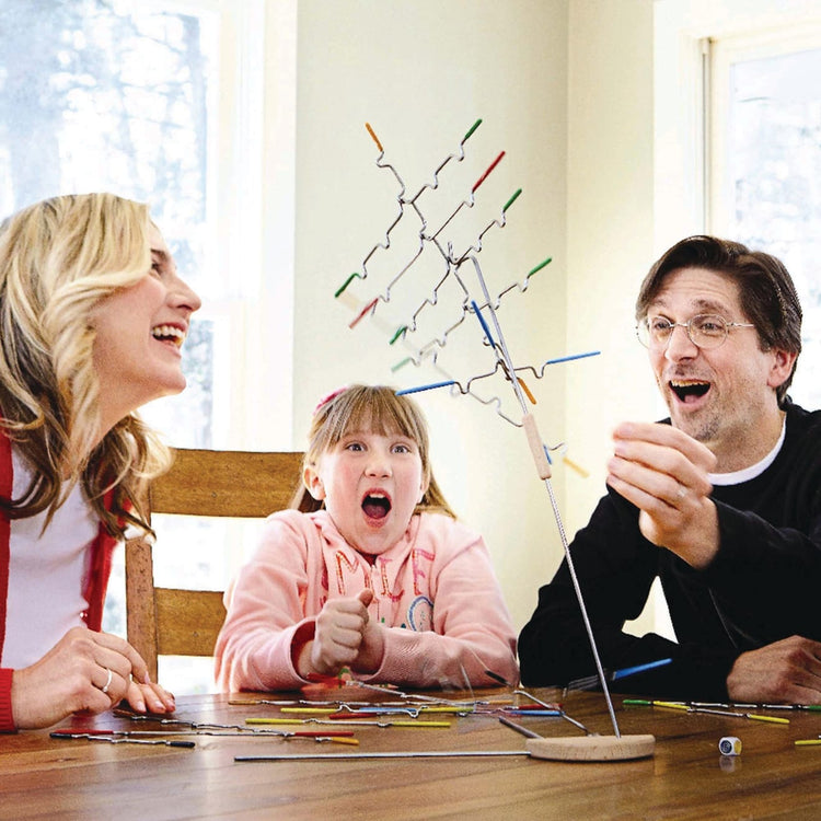 A kid playing with the Melissa & Doug Suspend Family Game (31 pcs)