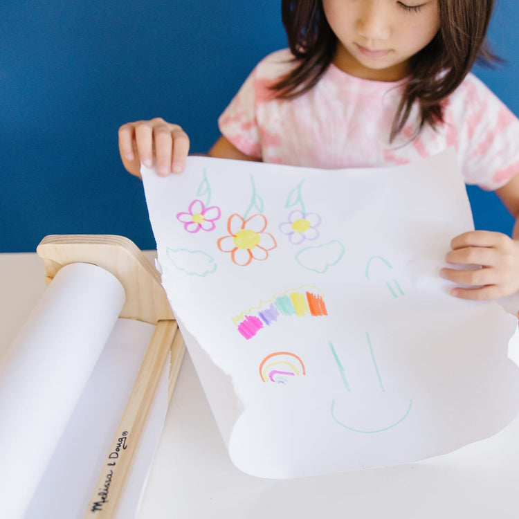 The front of the box for the Melissa & Doug Wooden Tabletop Paper Roll Dispenser With White Bond Paper (12 inches x 75 feet)