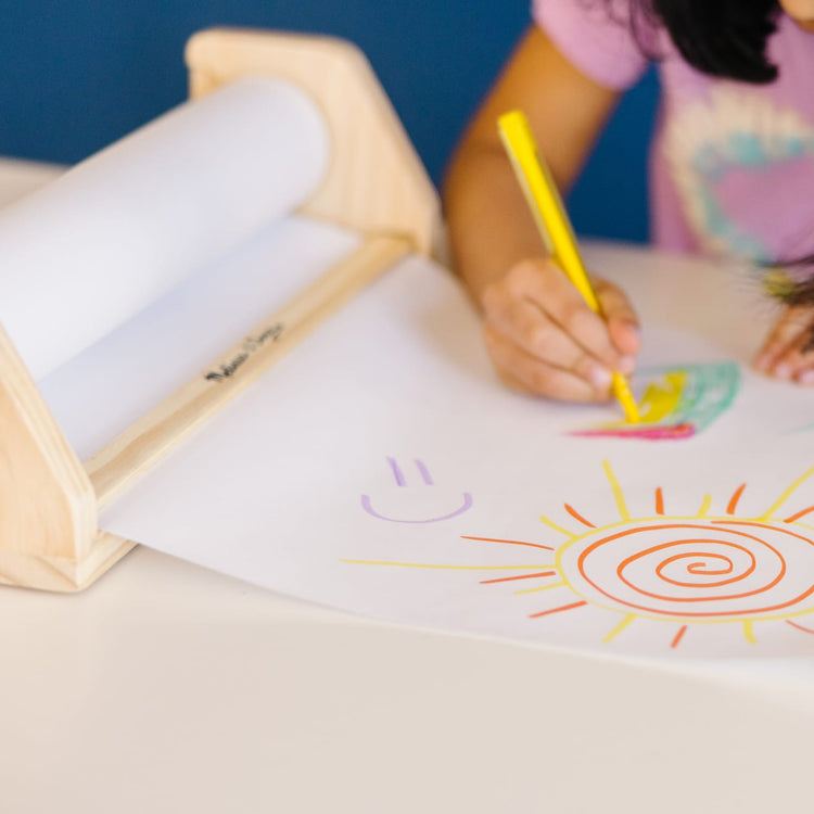 The front of the box for the Melissa & Doug Wooden Tabletop Paper Roll Dispenser With White Bond Paper (12 inches x 75 feet)