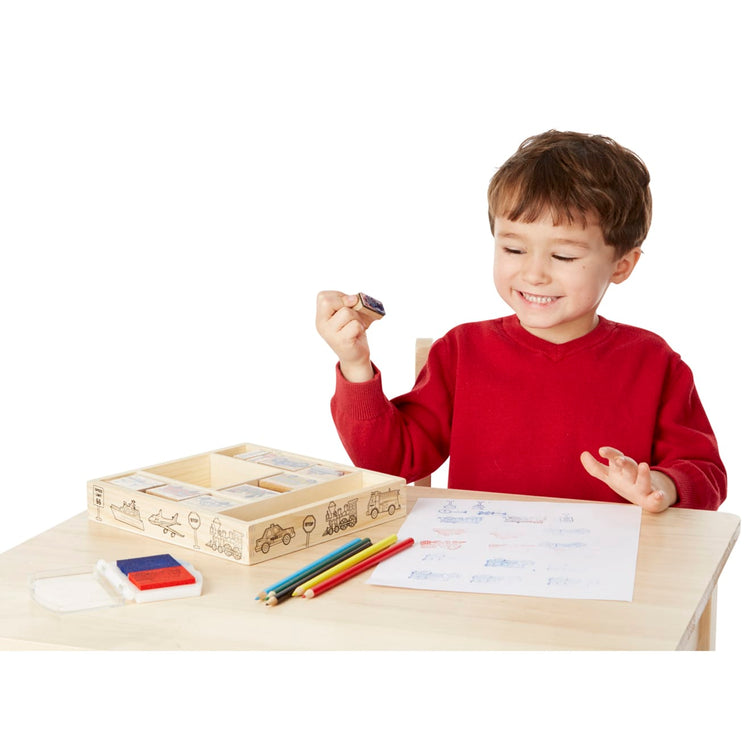 A child on white background with the Melissa & Doug Wooden Stamp Set: Vehicles - 10 Stamps, 5 Colored Pencils, 2-Color Stamp Pad