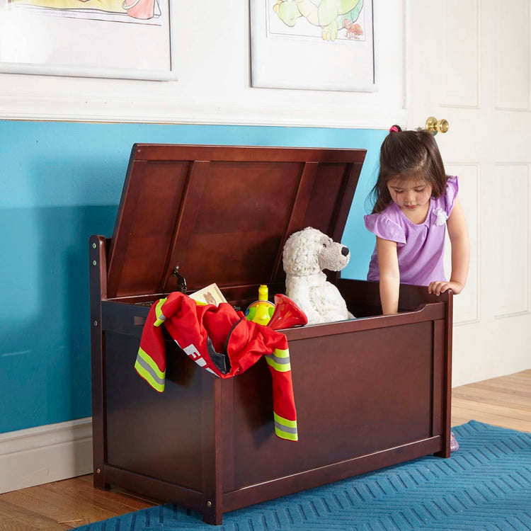 A kid playing with the Melissa & Doug Wooden Toy Chest (Espresso)