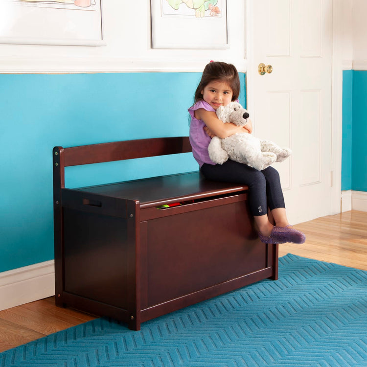 A kid playing with the Melissa & Doug Wooden Toy Chest (Espresso)