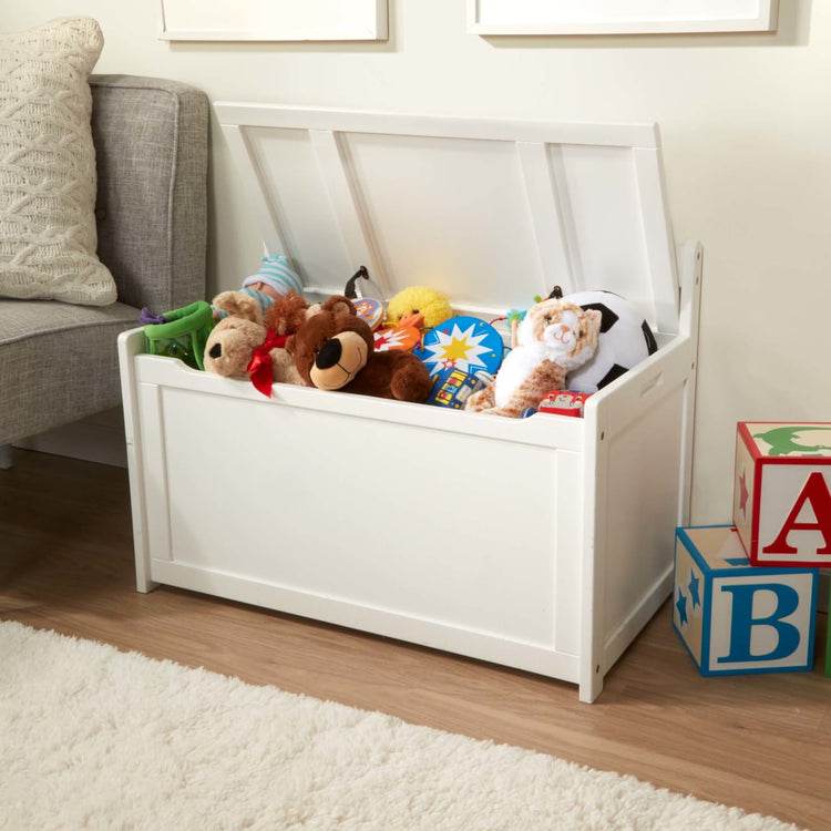 A kid playing with the Melissa & Doug Wooden Toy Chest (White)